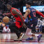 
              Toronto Raptors' Pascal Siakam, left, and Philadelphia 76ers' Tobias Harris eye a loose ball during the first half of an NBA basketball game Tuesday, Dec. 28, 2021, in Toronto. (Chris Young/The Canadian Press via AP)
            