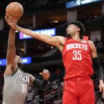 
              Houston Rockets center Christian Wood (35) and Brooklyn Nets forward Paul Millsap go for a rebound during the first half of an NBA basketball game, Wednesday, Dec. 8, 2021, in Houston. (AP Photo/Eric Christian Smith)
            