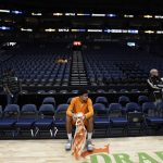 
              Tennessee forward Olivier Nkamhoua (13) sits on the bench after an NCAA basketball game was cancelled due to COVID-19 protocols within the Memphis program on Saturday, Dec. 18, 2021, in Nashville, Tenn. (AP Photo/Mark Zaleski)
            
