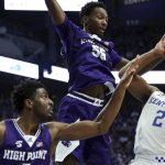
              Kentucky's Sahvir Wheeler (2) shoots while pressured by High Point's Zack Austin (55) and Bryant Randleman (5) during the first half of an NCAA college basketball game in Lexington, Ky., Friday, Dec. 31, 2021. (AP Photo/James Crisp)
            