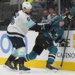 San Jose Sharks right wing Timo Meier (28) is checked into the boards by Seattle Kraken defenseman Adam Larsson (6) during the first period of an NHL hockey game Tuesday, Dec. 14, 2021, in San Jose, Calif. (AP Photo/Tony Avelar)