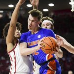 
              Florida forward Colin Castleton (12) tries to push past Oklahoma forward Jalen Hill, left, during the first half of an NCAA college basketball game in Norman, Okla., Wednesday, Dec. 1, 2021. (AP Photo/Kyle Phillips)
            