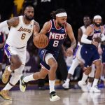 
              Brooklyn Nets guard Patty Mills (8) controls the ball against Los Angeles Lakers forward LeBron James (6) during the first half of an NBA basketball game in Los Angeles, Saturday, Dec. 25, 2021. (AP Photo/Ashley Landis)
            