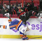 
              Ottawa Senators left wing Tim Stutzle (18) and New York Islanders left wing Anthony Beauvillier (18) fall after a hit  during the second period of an NHL hockey game Tuesday, Dec. 7, 2021, in Ottawa, Ontario. (Justin Tang/The Canadian Press via AP)
            