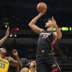 
              Miami Heat center Omer Yurtseven (77) shoots over Indiana Pacers center Myles Turner during the first half of an NBA basketball game in Indianapolis, Friday, Dec. 3, 2021. (AP Photo/AJ Mast)
            