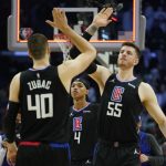 
              Los Angeles Clippers guard Brandon Boston Jr. (4) watches as center Ivica Zubac (40) and center Isaiah Hartenstein (55) celebrate after a 114-111 win over the Boston Celtics in an NBA basketball game in Los Angeles, Wednesday, Dec. 8, 2021. (AP Photo/Ashley Landis)
            