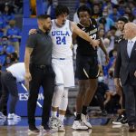 
              UCLA guard Jaime Jaquez Jr. (24) leaves the court with an injury after he was fouled by Colorado forward Jabari Walker (12) during the first half of an NCAA college basketball game in Los Angeles, Wednesday, Dec. 1, 2021. (AP Photo/Ashley Landis)
            