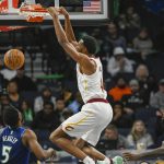 
              Cleveland Cavaliers forward Evan Mobley, center, dunks as Minnesota Timberwolves guards Malik Beasley, (5) and Patrick Beverley look on during the first half of an NBA basketball game Friday, Dec. 10, 2021, in Minneapolis. (AP Photo/Craig Lassig)
            