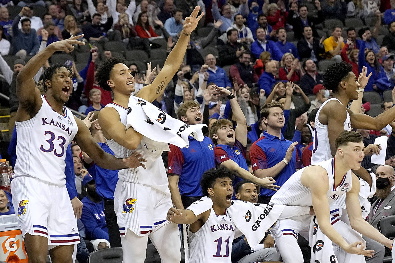 Kansas players celebrate after a teammate's basket during the second half of an NCAA college basket...