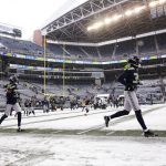 
              Seattle Seahawks players run on a partially snow-cleared field before an NFL football game against the Chicago Bears, Sunday, Dec. 26, 2021, in Seattle. Snow blanketed parts of the Pacific Northwest on Sunday because of unusually cold temperatures in the region. Between 3 and 5 inches of snow fell in Seattle overnight and frigid temperatures in the region could tie or break records in the coming days. (AP Photo/Lindsey Wasson)
            