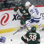 
              Minnesota Wild right wing Mats Zuccarello (36) and Toronto Maple Leafs center William Nylander (88) battle for the puck during the first period of an NHL hockey game, Saturday, Dec. 4, 2021, in St. Paul, Minn. (AP Photo/Andy Clayton-King)
            