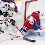 
              Montreal Canadiens goaltender Jake Allen, right, knocks the puck away from Chicago Blackhawks' Brandon Hagel during second-period NHL hockey game action in Montreal, Thursday, Dec. 9, 2021. (Paul Chiasson/The Canadian Press via AP)P)
            