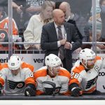 
              Philadelphia Flyers interim coach Mike Yeo stands behind the bench during the first period of the team's NHL hockey game against the Seattle Kraken, Wednesday, Dec. 29, 2021, in Seattle. (AP Photo/Ted S. Warren)
            