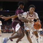 
              Southern California guard Boogie Ellis, right, drives past Eastern Kentucky guard Dashawn Jsckson during the first half of an NCAA college basketball game Tuesday, Dec. 7, 2021, in Los Angeles. (AP Photo/Ringo H.W. Chiu)
            