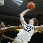 
              Iowa forward Patrick McCaffery (22) is fouled by Southeastern Louisiana guard Roger McFarlane, left, while driving to the basket during the second half of an NCAA college basketball game, Tuesday, Dec. 21, 2021, in Iowa City, Iowa. Iowa won 93-62. (AP Photo/Charlie Neibergall)
            