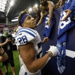 
              FILE - Indianapolis Colts running back Jonathan Taylor (28) signs autographs for fans after an NFL football game against the Houston Texans, Sunday, Dec. 5, 2021, in Houston. Taylor was among the athletes who either won or lost the most money for sports bettors in 2021, according to several national sports books. (AP Photo/Tyler Kaufman, File)
            