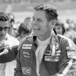 
              FILE - Bobby Unser is a happy man as he accepts congratulations in the winner's circle for his triumph in the California 500 at Ontario Motor Speedway in Ontario, Calif., March 11, 1974. He beat his brother, Al, by a half second to win $70,250. Al Unser, one of only four drivers to win the Indianapolis 500 a record four times, died Thursday, Dec. 9, 2021, following years of health issues. He was 82. (AP Photo, File)
            