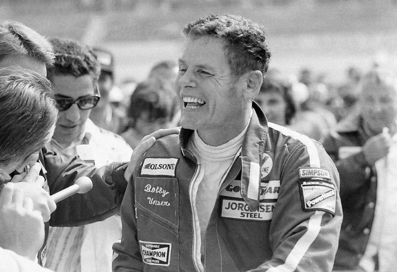 FILE - Bobby Unser is a happy man as he accepts congratulations in the winner's circle for his triu...