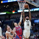 
              New Orleans Pelicans forward Brandon Ingram (14) pulls down a rebound over Detroit Pistons guard Cade Cunningham (2) in the first half of an NBA basketball game in New Orleans, Friday, Dec. 10, 2021. (AP Photo/Gerald Herbert)
            