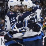 
              Winnipeg Jets' Mark Scheifele, Blake Wheeler and Kyle Connor, from left, celebrate Scheifele's goal against the Vancouver Canucks during the second period of an NHL hockey game Friday, Dec. 10, 2021, in Vancouver, British Columbia. (Darryl Dyck/The Canadian Press via AP)
            