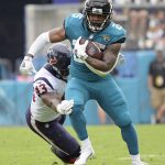 
              Jacksonville Jaguars running back James Robinson, right, tries to get past Houston Texans middle linebacker Neville Hewitt (43) during the first half of an NFL football game, Sunday, Dec. 19, 2021, in Jacksonville, Fla. (AP Photo/Phelan M. Ebenhack)
            