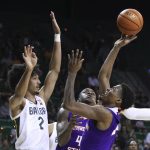 
              Northwestern State guard Cedric Garrett, right, shoots over Baylor guard Kendall Brown, left, during the first half of an NCAA college basketball game Tuesday, Dec. 28, 2021, in Waco, Texas. (AP Photo/Rod Aydelotte)
            