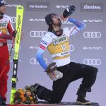 
              Second placed Austria's Otmar Striedinger, left, watches the winner United States' Bryce Bennett celebrate on podium after an alpine ski, men's World Cup downhill race, in Val Gardena, Italy, Saturday, Dec.18, 2021. (AP Photo/Alessandro Trovati)
            