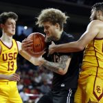 
              Long Beach State forward Romelle Mansel, center, pulls down a rebound between Southern California guard Drew Peterson, left, and forward Isaiah Mobley during the second half of an NCAA college basketball game in Los Angeles, Sunday, Dec. 12, 2021. (AP Photo/Alex Gallardo)
            