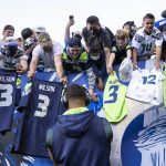 
              FILE - Seattle Seahawks quarterback Russell Wilson signs autographs for fans before an NFL football game against the Los Angeles Chargers in Seattle on Aug. 28, 2021. (AP Photo/Stephen Brashear, File)
            