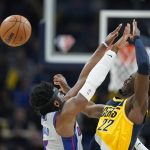 
              Indiana Pacers' Caris LeVert (22) makes a pass against Detroit Pistons' Hamidou Diallo (6) during the first half of an NBA basketball game, Thursday, Dec. 16, 2021, in Indianapolis. (AP Photo/Darron Cummings)
            