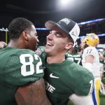 
              Michigan State players embrace after the Peach Bowl NCAA college football game between Pittsburgh and Michigan State, Thursday, Dec. 30, 2021, in Atlanta. Michigan State won 31-21. (AP Photo/John Bazemore)
            
