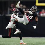 
              Atlanta Falcons wide receiver Russell Gage (14) makes a leaping catch against Tampa Bay Buccaneers cornerback Rashard Robinson (28) during the second half of an NFL football game, Sunday, Dec. 5, 2021, in Atlanta. (AP Photo/John Bazemore)
            