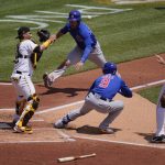 
              FILE - Pittsburgh Pirates first baseman Will Craig, right, tosses the ball to catcher Michael Perez, left, after Chicago Cubs' Javier Baez (9) hit a fielder's choice third to first and was caught in a rundown between home a first during the third inning of a baseball game in Pittsburgh, May 27, 2021. Cub's Willson Contreras, top center, scores on the play and Báez reached second on an errant throw by Pirates' catcher Perez. In a totally forgettable season for the Chicago Cubs, Baez wins the Newby award for best baserunning. (AP Photo/Gene J. Puskar, File)
            