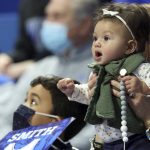 
              Seven month old Scotland Smith, right, and her cousin Ross Smith cheer for their grandfather, High Point head coach Tubby Smith and his team during the second half of an NCAA college basketball game between High Point and Kentucky in Lexington, Ky., Friday, Dec. 31, 2021. Kentucky won 92-48. Before the game Smith was honored with a jersey retirement. (AP Photo/James Crisp)
            