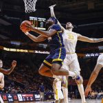 
              UNC-Greensboro forward Jalen White (14) shoots past Tennessee forward Uros Plavsic (33) during an NCAA college basketball game Saturday, Dec. 11, 2021, in Knoxville, Tenn. (AP Photo/Wade Payne)
            