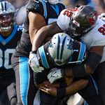 
              Carolina Panthers quarterback Cam Newton is sacked by Tampa Bay Buccaneers defensive end William Gholston during the first half of an NFL football game Sunday, Dec. 26, 2021, in Charlotte, N.C. (AP Photo/Jacob Kupferman)
            