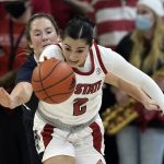 
              North Carolina State guard Raina Perez (2) and Saint Mary's guard Madeline Holland chase the ball during the second half of an NCAA college basketball game in Raleigh, N.C., Sunday, Dec. 12, 2021. (AP Photo/Gerry Broome)
            