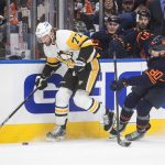 
              Pittsburgh Penguins' Jeff Carter (77) works for the puck next to Edmonton Oilers' Markus Niemelainen (80) during the first period of an NHL hockey game Wednesday, Dec 1, 2021, in Edmonton, Alberta. (Jason Franson/The Canadian Press via AP)
            