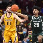 
              Michigan State guard Malik Hall (25) reaches for a rebound before Minnesota forward Jamison Battle can get to it during the first half an NCAA college basketball game Wednesday, Dec. 8, 2021, in Minneapolis. (AP Photo/Craig Lassig)
            