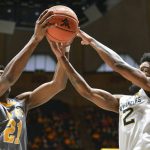 
              Kent State forward Justyn Hamilton (21) and West Virginia guard Taz Sherman (12) vie for a rebound during the first half of an NCAA college basketball game in Morgantown, W.Va., Sunday, Dec. 12, 2021. (AP Photo/William Wotring)
            