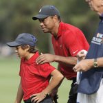 
              Tiger Woods, right, talks with his son Charlie Woods on the second green during the second round of the PNC Championship golf tournament Sunday, Dec. 19, 2021, in Orlando, Fla. (AP Photo/Scott Audette)
            
