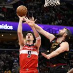 
              Washington Wizards forward Deni Avdija (9) shoots against Cleveland Cavaliers forward Kevin Love, right, during the first half of an NBA basketball game, Thursday, Dec. 30, 2021, in Washington. (AP Photo/Nick Wass)
            