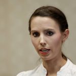 
              FILE - Former gymnast Rachael Denhollander speaks about Larry Nassar in Lansing, Mich., Nov. 22, 2017. The legal wrangling between USA Gymnastics and the victims of sexual abuse by Nassar, among others, is over. A federal bankruptcy court in Indianapolis on Monday, Dec. 13, 2021, confirmed a $380 million settlement between USA Gymnastics and the U.S. Olympic and Paralympic Committee and the hundreds of victims, ending one aspect of the fallout of the largest sexual abuse scandal in the history of the U.S. Olympic movement. (AP Photo/Paul Sancya, File)
            