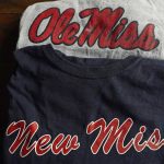 
              The top t-shirt is emblazoned with one of the University of Mississippi's logos, while the bottom shirt, a New Miss product, sports a logo nearly identical to the university's ubiquitous Ole Miss brand, as photographed Nov. 9, 2021 in Jackson, Miss. The university objects to the trademark application filed by the person marketing the New Miss brand. (AP Photo/Rogelio V. Solis)
            