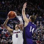 
              Gonzaga guard Julian Strawther (0) shoots while pressured by North Alabama forward Payton Youngblood (14) during the first half of an NCAA college basketball game, Tuesday, Dec. 28, 2021, in Spokane, Wash. (AP Photo/Young Kwak)
            