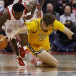 
              Ohio State's Jamari Wheeler, left, and Towson's Chase Paar chase a loose ball during the second half of an NCAA college basketball game Wednesday, Dec. 8, 2021, in Columbus, Ohio. (AP Photo/Jay LaPrete)
            