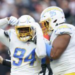 
              Los Angeles Chargers' Chris Rumph II (94) and Christian Covington (95) celebrate a play during the second half of an NFL football game against the Cincinnati Bengals, Sunday, Dec. 5, 2021, in Cincinnati. (AP Photo/Michael Conroy)
            