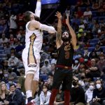 
              Cleveland Cavaliers guard Ricky Rubio (3) shoots over New Orleans Pelicans center Jonas Valanciunas (17) during the second quarter of an NBA basketball game in New Orleans, Tuesday, Dec. 28, 2021. (AP Photo/Derick Hingle)
            