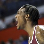 
              Texas Southern forward Joirdon Karl Nicholas celebrates on the bench against Florida during the second half of an NCAA college basketball game Monday, Dec. 6, 2021, in Gainesville, Fla. (AP Photo/Matt Stamey)
            