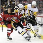 
              New Jersey Devils left wing Janne Kuokkanen (59) battles for the puck along the boards with Pittsburgh Penguins defenseman Brian Dumoulin (8) and Mike Matheson (5) during the second period of an NHL hockey game, Sunday, Dec.19, 2021, in Newark, N.J. (AP Photo/Bill Kostroun)
            